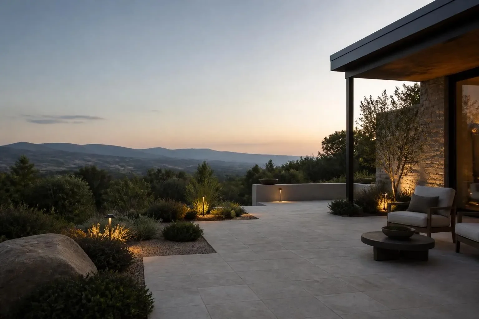 An outdoor retreat with seating and warm lighting at night